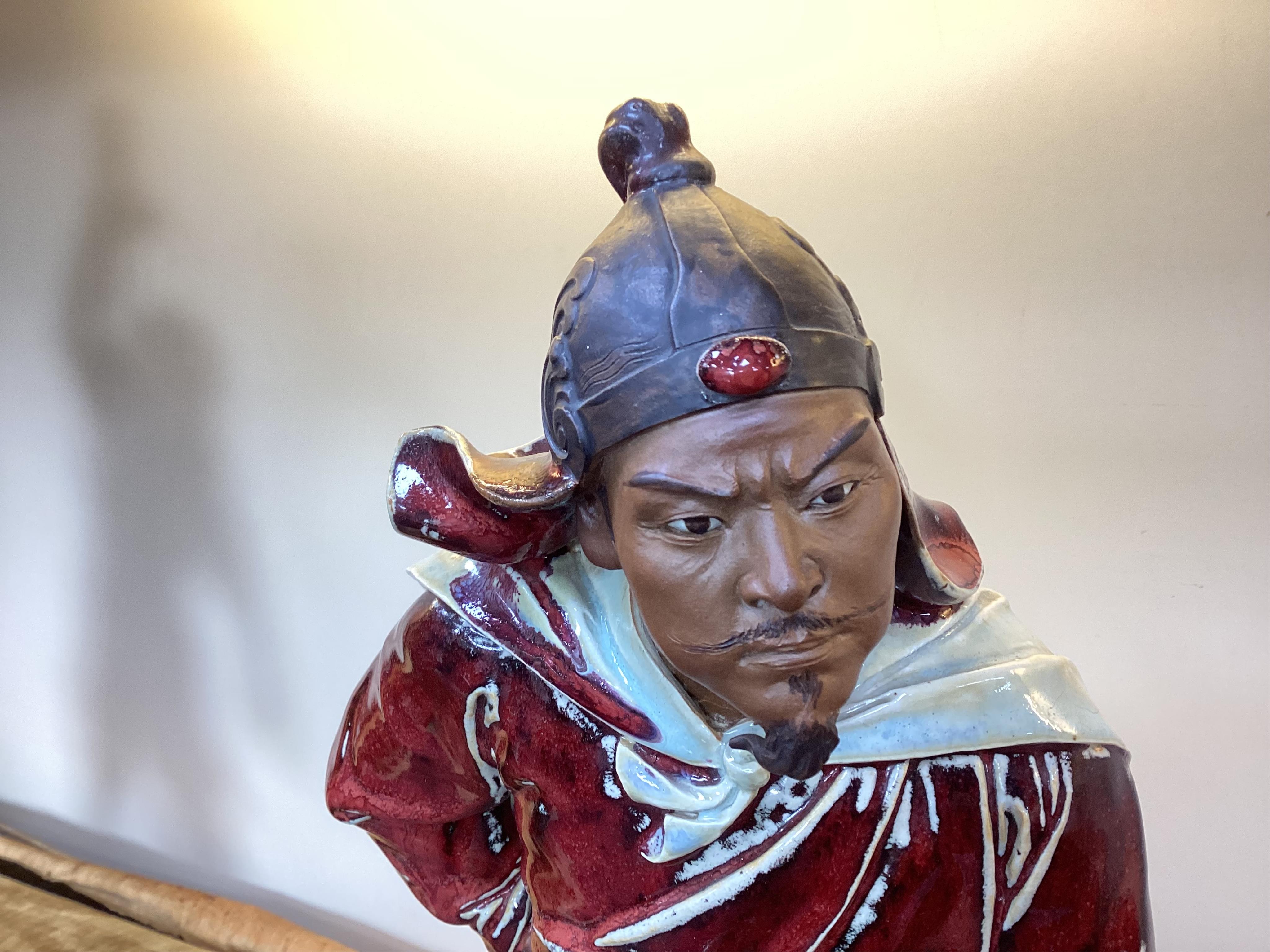 A large Chinese Shiwan stoneware figure of a warrior, 20th century